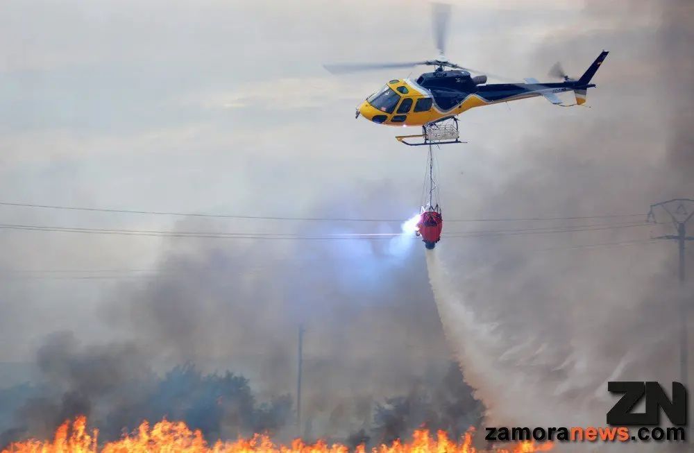 Imagen de archivo de un helicóptero descargando agua en un incendio