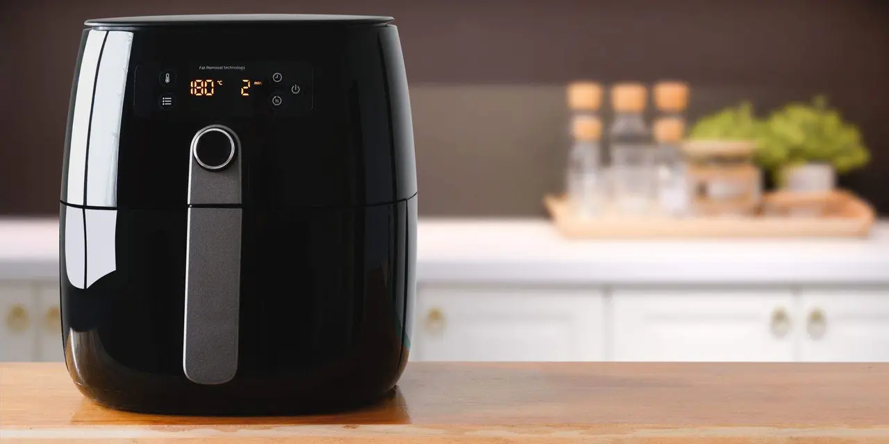 Air fryer machine cooking potato fried in kitchen.  Lifestyle of new normal cooking. 