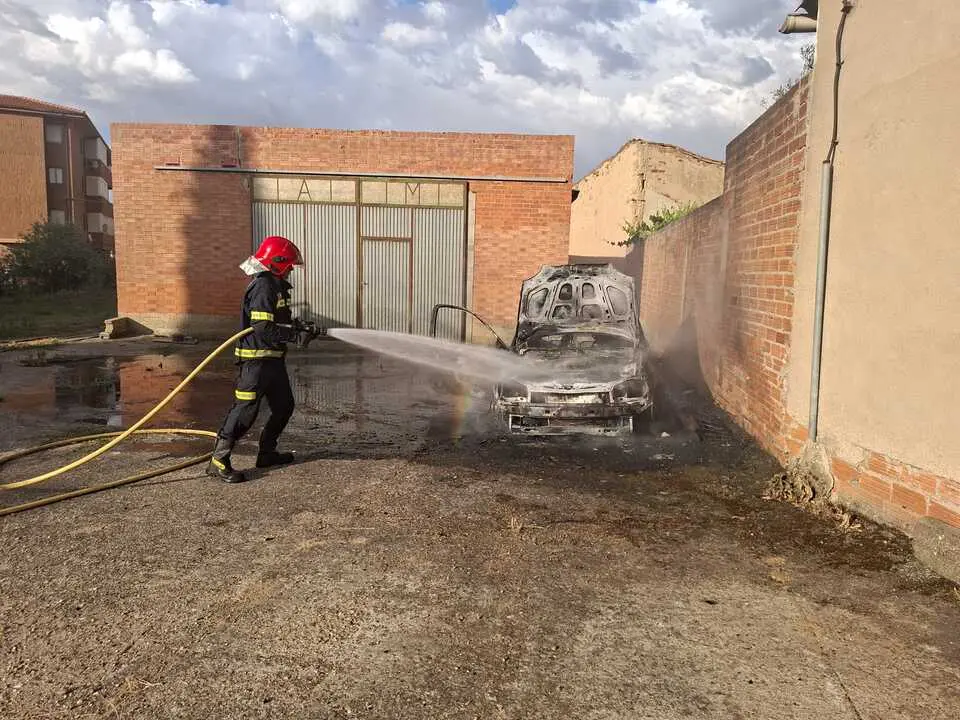 Un bombero trabaja en la extinci&oacute;n del incendio declarado en un veh&iacute;culo en Villalpando