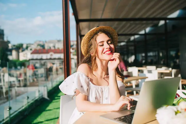 beautiful-girl-with-long-hair-in-hat-sits-at-table-on-the-terrace-in-cafe-she-wears-a-white-dress-wi