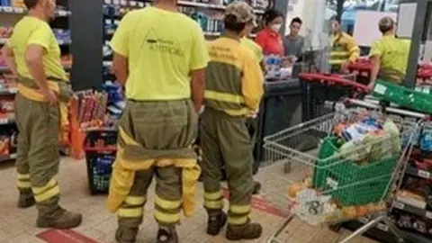 Operarios de extinción de incendios en un supermercado