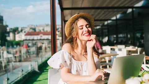 beautiful-girl-with-long-hair-in-hat-sits-at-table-on-the-terrace-in-cafe-she-wears-a-white-dress-wi