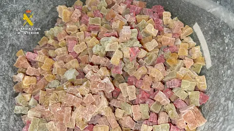 v
La Guardia Civil ha llevado a cabo una operación en la que se ha desmantelado un laboratorio clandestino en el centro de Barcelona en el que se fabricaban golosinas de marihuana en forma de ositos de colores. En la operación han sido detenidas tres personas de origen británico, holandés y ruso por la presunta comisión de un delito de tráfico de drogas.

 
Han sido intervenidos 70 envíos, 5000 golosinas de marihuana, 12 kg de marihuana, 6 kg de hachís y numeroso material empleado para la fabricación, envasado y distribución de la droga y fueron detenidas tres personas por la presunta comisión de un delito de tráfico de drogas que han ingresado en prisión.
 
La investigación se inició tras la interceptación de una serie de envíos de paquetería postal de golosinas creadas con marihuana a diferentes puntos de Europa (Alemania, Francia, Italia, Holanda, Portugal, Croacia).
Los agentes estrecharon el cerco en un piso del centro de Barcelona pudiendo comprobar que se trataba de un laboratorio donde la organización criminal creaba las golosinas en forma de ositos de colores a base de marihuana y otros componentes químicos perjudiciales para la salud.
 
“Deep Web”
La organización criminal, asentada en Barcelona, recibía los pedidos a través de aplicaciones encriptadas de mensajería instantánea o en la “Deep Web” y enviaban mediante paquetería postal las golosinas de marihuana ocultas en su interior a numerosos países de Europa.
 
La Guardia Civil ha llevado a cabo una operación en la que se ha desmantelado un laboratorio clandestino en el centro de Barcelona en el que se fabricaban golosinas de marihuana en forma de ositos de colores. En la operación han sido detenidas tres personas de origen británico, holandés y ruso por la presunta comisión de un delito de tráfico de drogas.

 
Han sido intervenidos 70 envíos, 5000 golosinas de marihuana, 12 kg de marihuana, 6 kg de hachís y numeroso material empleado para la fabricación, envasado y distribución de la droga y fueron detenidas tres personas por la presunta comisión de un delito de tráfico de drogas que han ingresado en prisión.
 
La investigación se inició tras la interceptación de una serie de envíos de paquetería postal de golosinas creadas con marihuana a diferentes puntos de Europa (Alemania, Francia, Italia, Holanda, Portugal, Croacia).
Los agentes estrecharon el cerco en un piso del centro de Barcelona pudiendo comprobar que se trataba de un laboratorio donde la organización criminal creaba las golosinas en forma de ositos de colores a base de marihuana y otros componentes químicos perjudiciales para la salud.
 
“Deep Web”
La organización criminal, asentada en Barcelona, recibía los pedidos a través de aplicaciones encriptadas de mensajería instantánea o en la “Deep Web” y enviaban mediante paquetería postal las golosinas de marihuana ocultas en su interior a numerosos países de Europa.
 
La operación ha sido llevada a cabo por agentes de la Unidad Orgánica de Policía Judicial de la Guardia Civil de Barcelona