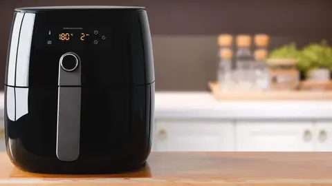 Air fryer machine cooking potato fried in kitchen.  Lifestyle of new normal cooking. 