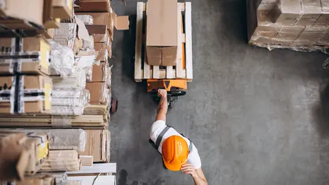 Young man working at a warehouse with boxes