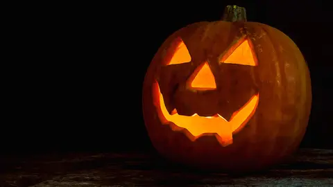 Halloween pumpkin head jack lantern on wooden background
