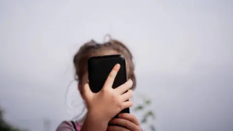 Fotografía de archivo niña con un móvil