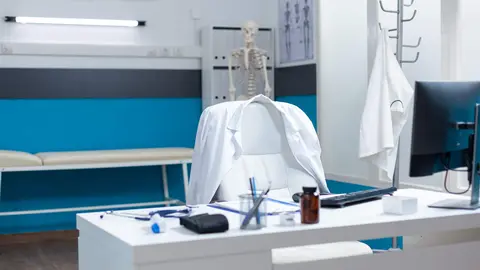 Empty modern medical office having disease documents on table equipped with contemporary furniture. Hospital workplace with nobody in it ready for sickness consultation. Medicine support