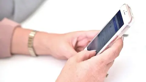 Una persona utiliza su teléfono móvil. Imagen de archivo