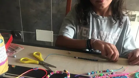 Daniela haciendo pulseras - imagen redes
