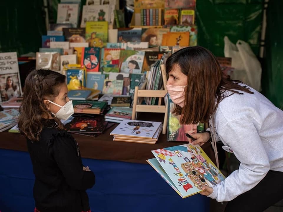 Sandra Alonso con una pequeña lectora durante una de las Ferias del Libro