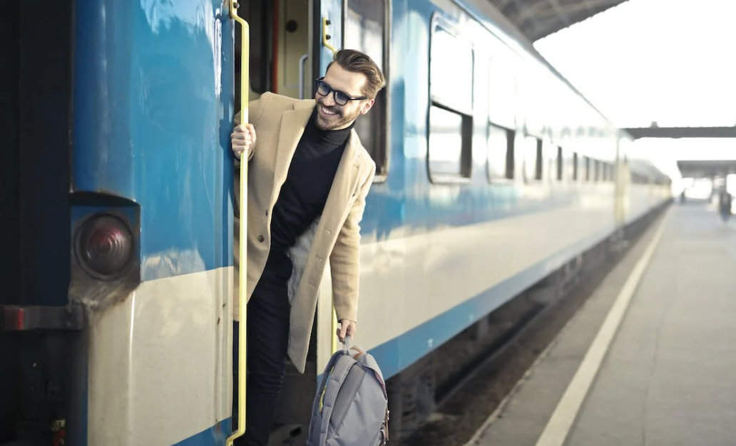 Man Wearing Beige Overcoat Inside Train